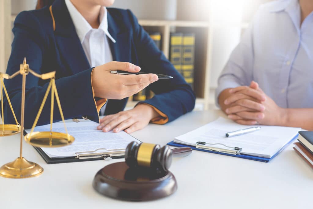 Female Lawyer Explaining Legal Situation And Discussing With Con